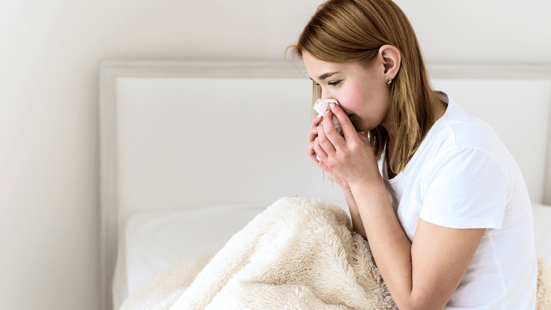 Person waking up refreshed in a bright clean bedroom in the morning